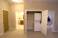 From kitchen looking toward entrance (L), bath (center), laundry (double doors), BR (right)