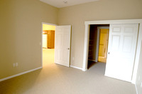 Bedroom, looking back to main area (left door) and at walk-through closet to bathroom (right door)